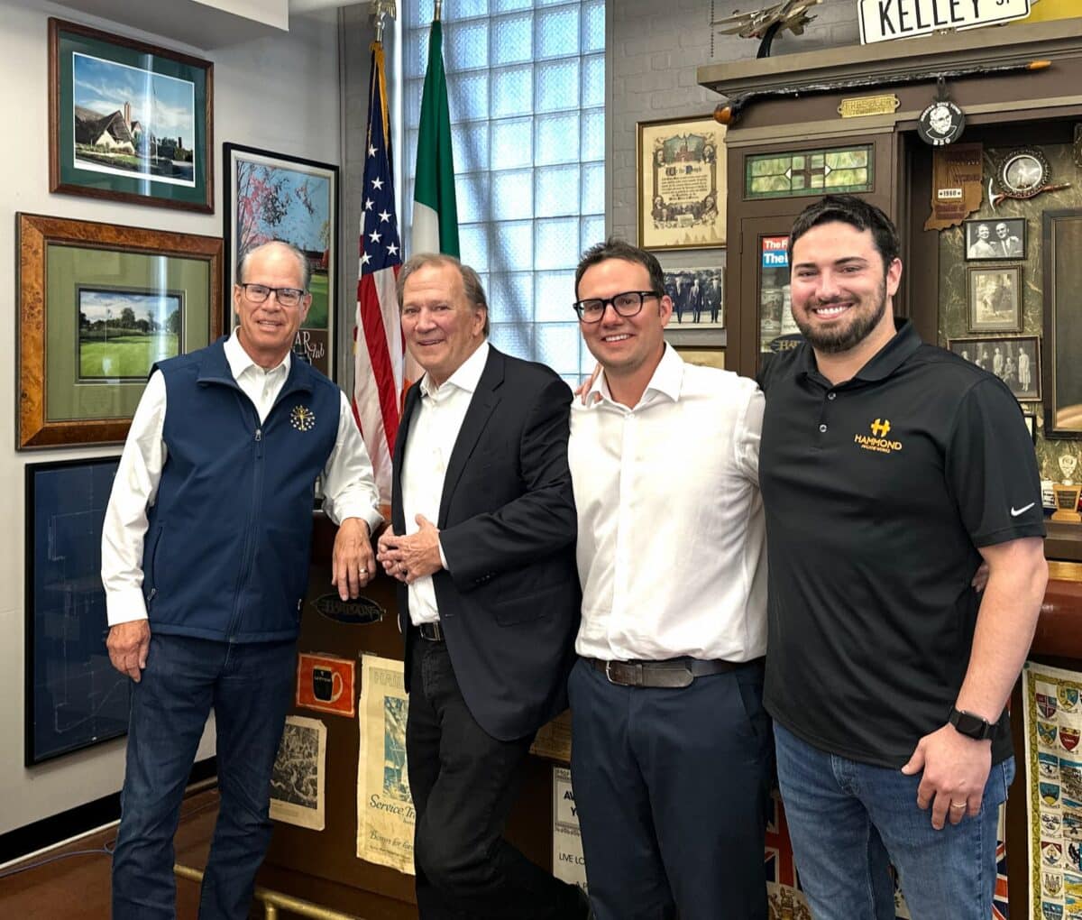 Mike Braun standing with Hammond Machine Works employees