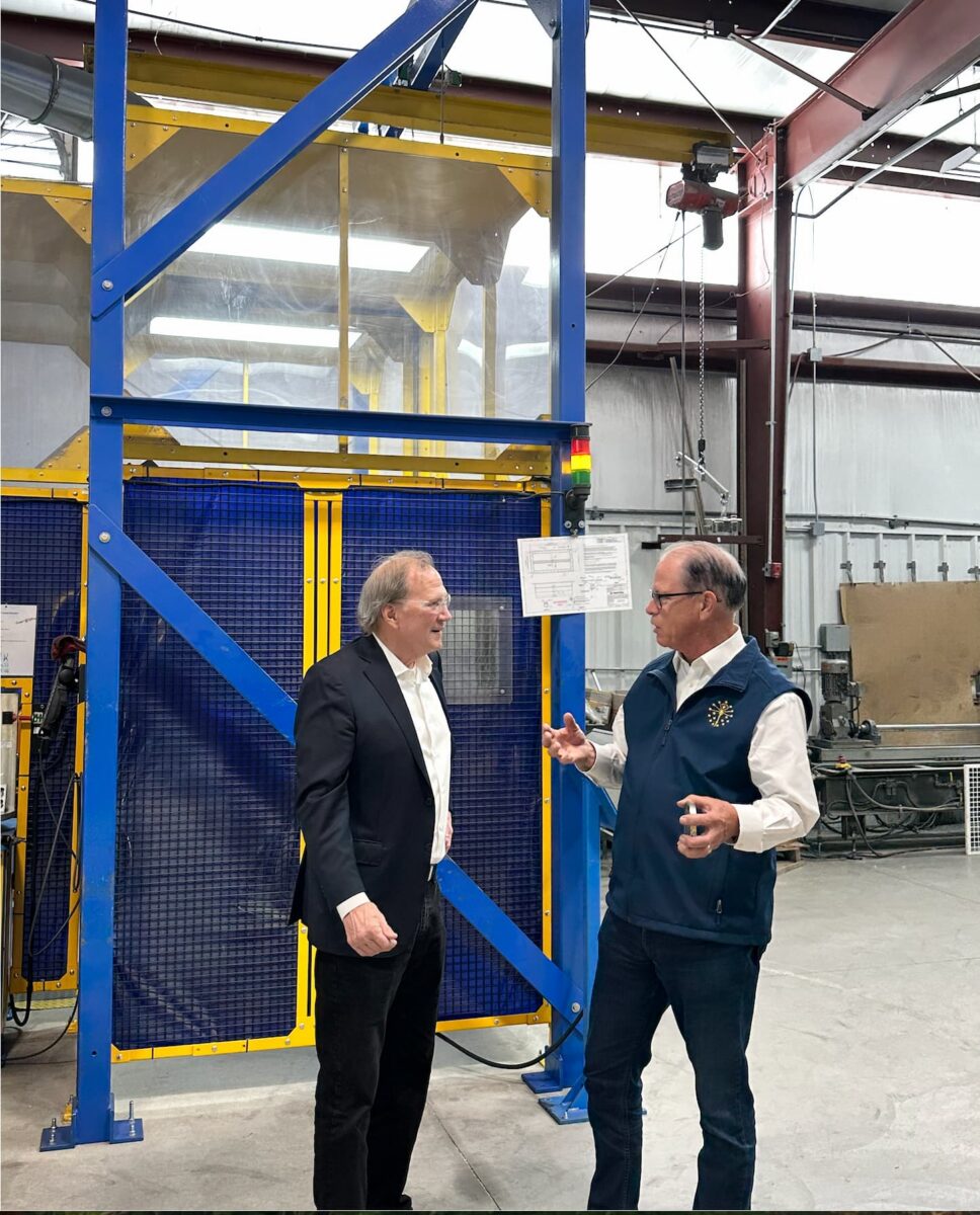 Mike Braun talking with Hammond Machine Works employee
